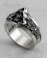 Angled view of handcrafted silver skull ring highlighting the deep eye sockets and antique oxidized finish on the hood