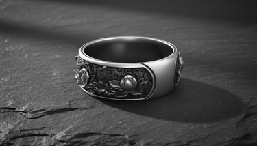 Close-up of Japanese ornamental design on handcrafted silver ring band against textured background