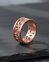 Angled shot of rose gold nature ring displaying inner band smooth finish and textured exterior