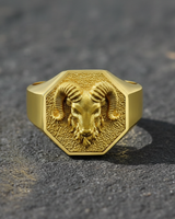 Gold variant of the ram signet ring showcasing the intricate animal head design and octagonal shape on texture