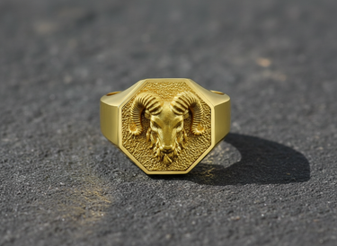 Gold variant of the ram signet ring showcasing the intricate animal head design and octagonal shape on texture