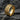 Angled view of rugged ring design showing polished smooth rails and deep organic texturing details