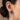 Model wearing handcrafted silver angel earring showing scale and fit on the earlobe