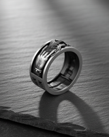 Side view of silver music ring showing rock on hand gesture and studded wristband detail