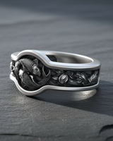 Side angle of silver Japanese koi ring showing detailed lotus flower engravings and thick band profile