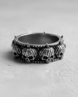 Front view of silver skull pumpkin ring showing oxidized finish and detailed pumpkin stems on a grey background
