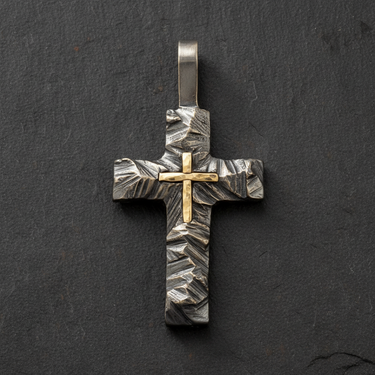 Top down view of two tone silver cross pendant highlighting sturdy bail and detailed rock texture design
