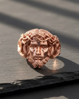 Rose gold plated silver Jesus ring with a detailed crown of thorns, shown from the front on a dark slate surface.
