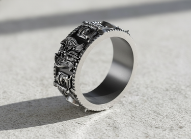 Side angle of wide band silver ring showing thickness and oxidized medieval engravings