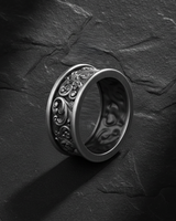 Angled perspective of 925 sterling silver ornamental ring showing thick band profile and oxidized finish details