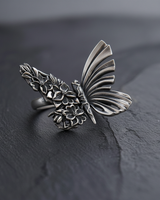 925 sterling silver butterfly ring featuring intricate flower engravings and oxidized finish
