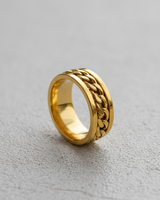 Gold vermeil silver chain spinner ring featuring rotating curb chain inlay on textured background