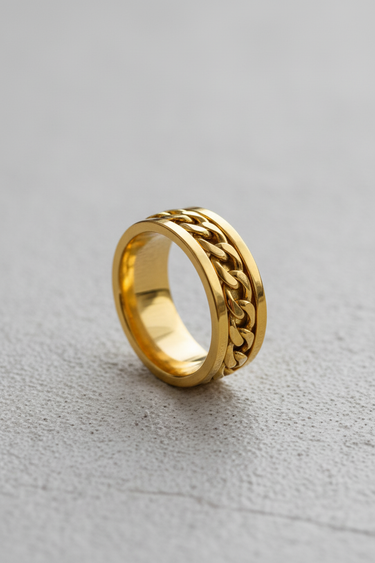 Gold vermeil silver chain spinner ring featuring rotating curb chain inlay on textured background