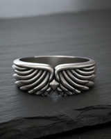Front view of 925 sterling silver wing ring showing intricate feather texture and symmetrical biker style design