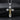 Close up of silver and gold tone orthodox crucifix pendant with detailed Jesus figure and screw accents
