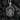 Back view of silver protection pendant showing Protect Us inscription and intricate floral cross design