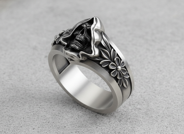 Side angle of handcrafted silver gothic ring showing detailed floral engravings and skull