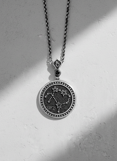 Reverse side of silver zodiac pendant featuring Ophiuchus constellation stars and symbols
