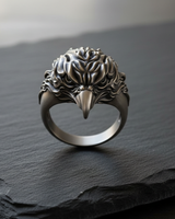 Front view of handcrafted 925 sterling silver eagle ring with detailed feathers on dark stone background