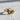 Wavy gemstone ring, gold vermeil, angled view on textured surface