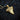 Scrollwork Shark Tooth Pendant, gold vermeil, angled view on charred wood