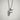 Bird Letter F Pendant, polished silver, front view against white textured wall