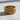 Close-up of Viking filigree ring highlighting the deeply carved 3D motifs resting on a lightly textured surface