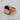 Angled view of 925 sterling silver filigree signet ring with rose gold plating resting on a textured light background