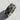Angled view of handcrafted sterling silver animal paw band highlighting the wide profile and deep texture