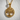 Close-up of 925 sterling silver Tree of Life pendant with gold finish resting on a textured white surface