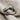 Hugging Arms Ring, oxidized silver, angled close-up view on linen