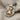 Virgo Maiden Zodiac Pendant, two-tone finish, angled perspective on fabric
