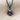 Heart clover pendant, black rhodium plated, front view on fabric