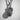 Angled close-up of handcrafted grenade pendant highlighting safety pin details and deep oxidized finish