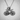 Close-up of vintage bicycle pendant highlighting the oxidized silver finish and fine metallic details on a textured surface.