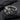 Detailed view of oxidized silver violet flower ring resting gracefully on a textured dark slate stone