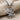 Sparkling doll pendant resting on beige textured fabric highlighting the brilliant stones and oxidized silver finish