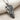 Close-up angled view of the equestrian horse skull pendant resting on fabric, emphasizing the dark oxidized finish