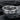 Close-up of Love Wins ring showing deep engraved oxidized text on dark textured slate