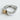 Close-up of elegant two-tone heart ring featuring detailed silver scrollwork and a brilliant center gemstone