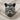 Close-up of handcrafted rockstar bulldog ring displaying intricate facial textures and sunglasses on woven fabric
