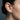 Side profile of female model wearing the unisex gear hoop earring highlighting its bold geometric proportions