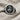 Close-up of the Orixa Oxossi ring resting on woven linen cloth, highlighting the premium 925 sterling silver craftsmanship
