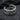 Close-up of handcrafted two-tone serpent cuff earring resting on dark stone highlighting oxidized silver texture