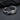 Close-up of the handcrafted oxidized silver fish earring resting elegantly on a dark textured stone background