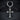 Close-up of the gothic cross earring resting on a dark slate background highlighting the inner engraved layered cross