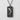 Seigaiha Koi Fish Pendant, oxidized, front view against textured wall