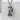 Maneki Neko Coin Pendant, oxidized, front view on concrete block