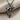 Arched Dolphin Pendant, black rhodium, product photo on linen