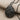 Spiral Conch Pendant, black rhodium, angled view on fabric